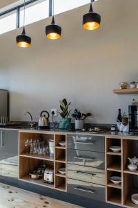 a kitchen with a counter with some lights above it at Opstal Stay in Rawsonville