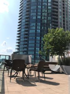 a patio with chairs and a table and a building at Executive 1 Bedroom Condo sleeps 2 in Toronto
