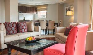 a living room with a couch and chairs and a table at Longonot Place Serviced Apartments in Nairobi