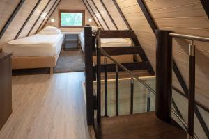 チェホチネクにあるKomfortowe domki przy Parku Zdrojowymのベッド2台と階段が備わる小さな客室です。