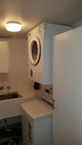 a kitchen with a washing machine on top of a counter at North Adelaide Apartment in Adelaide
