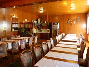 un comedor con una mesa larga y sillas en Helmerser Wirtshaus, en Struth-Helmershof