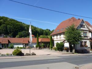 un edificio con una bandera en medio de una calle en Helmerser Wirtshaus, en Struth-Helmershof