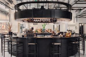 a bar with a black counter and stools at Blique by Nobis, Stockholm, a Member of Design Hotels™ in Stockholm