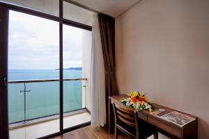a room with a desk and a large window at Lenid Ocean View Hotel in Nha Trang +148 photos