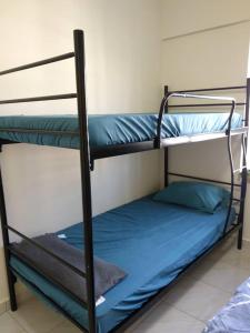 a couple of bunk beds in a room at The Whale - Bayview - Pool open in Port Dickson