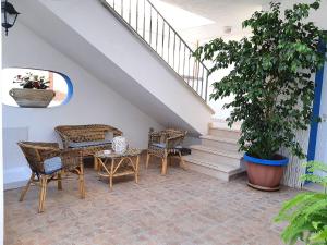 een patio met stoelen, een tafel en een trap bij B&B Antiche Stelle Salento in Salve