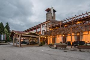 a large building with a tower on top of it at Paradise SPA Hotel in Tsigov Chark