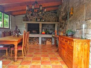 a kitchen with a wooden table and a stone wall at Villa Pazos in Nigrán