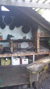 uma cozinha com uma mesa de madeira e um banco em Ambiance sud sauvage em Saint-Joseph