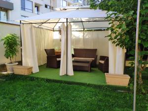 a gazebo with a table and chairs under it at Urban House in Sofia