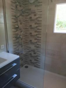 a bathroom with a shower with a glass door at Le Pech de Sireuil in Groléjac +13 photos