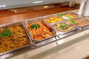 a buffet line with different types of food in trays at Medical SPA "Eglės sanatorija" Comfort Druskininkai in Druskininkai