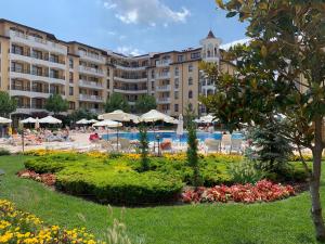 a hotel with a garden in front of a resort at Royal Sun in Sunny Beach