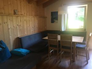 a dining room with a table and chairs and a window at Appartement Mühlhäusl in Auffach