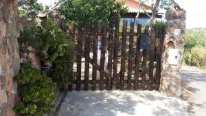 a wooden gate in front of a house at la maddalena in La Maddalena