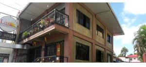 a building with two balconies on the side of it at Lipa Bed & Breakfast in Lipa