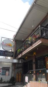 a building with a balcony on the side of it at Lipa Bed & Breakfast in Lipa