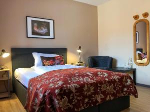 
Ein Bett oder Betten in einem Zimmer der Unterkunft Hotel Restaurant Denis
