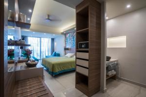 a bedroom with a bed and a room with a desk at Atrion Resort Hotel in Agia Marina Nea Kydonias