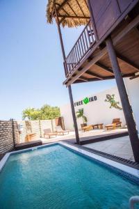 una piscina con sillas y una casa en Casa Free Wind Jeri, en Jericoacoara