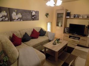 a living room with a couch and a coffee table at Haus Alexandra in Schöneberg