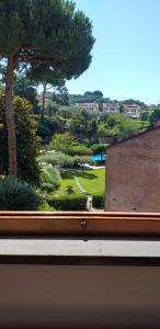 a view of a park from a window of a building at la casa del pittore Anna house in Lerici