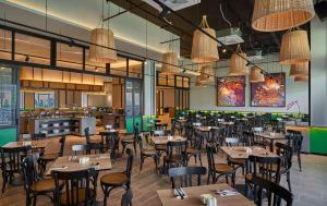 a restaurant with tables and chairs in a room at Swiss-Garden Hotel & Residences, Genting Highlands in Genting Highlands
