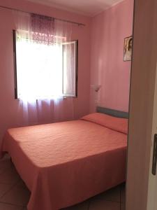 1 dormitorio con 2 camas y ventana en Villa Carla, en Vieste