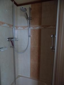 a bathroom with a shower with a tub and a sink at Haus Alexandra in Schöneberg +47 photos