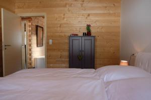 a bedroom with a bed and a wooden wall at Obern 41 in Leutasch