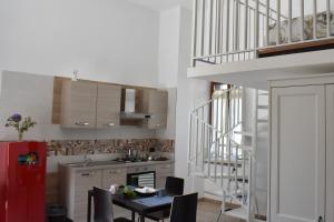 a kitchen with a staircase and a table and chairs at CASA SACA' in Pompei