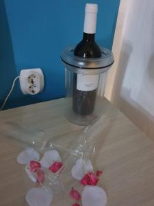 a bottle of wine and some flowers on a table at Heavenly House by the sea in Savudrija