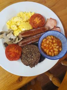 a plate of food including eggs, sausage, potatoes, beans, beans, at St Michaels Guest House in Elgin