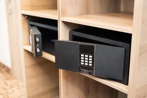 a microwave oven in a wooden book shelf at Z-Hotel Business & Spa in Otwock