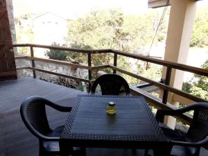 a table and chairs on a porch with a engagement ring at Casa Cardelina in Camporrells