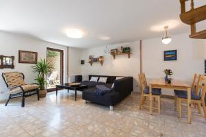 a living room with a couch and a table at Casa Flora 3-minutes’ walk from the beach in Novigrad Istria
