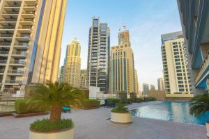 a view of a city skyline with a pool and buildings at Prime Retreats- Downtown Dubai in Dubai