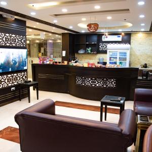 eine Lobby mit einem Wartebereich mit einem Sofa und einer Theke in der Unterkunft City Center Plaza Aparthotel in Dschidda
