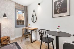 a dining room with a table and chairs and a window at Blubini Heritage House in Rovinj