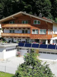 a house with solar panels on the front of it at Ferienwohnung Mayrhofer in Leogang