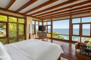 
a hotel room with a large window overlooking the ocean at Shangri-La Boracay in Boracay

