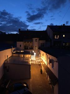 a night view of a rooftop of a building with lights at Schöndorf Hostel - virtual reception in Bratislava