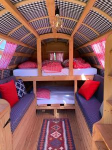 an interior of a bus with two beds in a room at #Glamping@De Verloren Sinjoor in Bladel