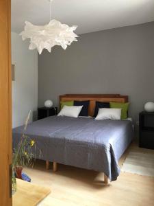 a bedroom with a bed with a blue comforter at Apartment am alten Markt in Stolberg
