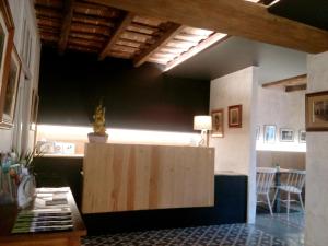 a room with a wooden partition in the middle of a room at CAN MENCIÓ - Plaça Major in Santa Pau