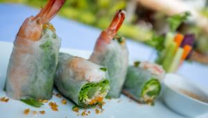 a group of food on a plate with chopsticks at La Rivière d' Angkor Resort in Siem Reap