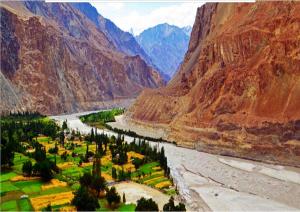 a painting of a valley with a river and mountains at Julley World Camp in Nubra