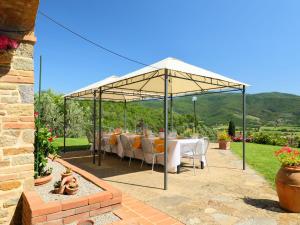a table set up under a tent in a garden at Villa Zen by Interhome in Santa Cristina