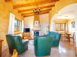 ein Wohnzimmer mit grünen Stühlen und einem Tisch in der Unterkunft Villa Cala Torta Na Lluny by Interhome in Cala Mesquida